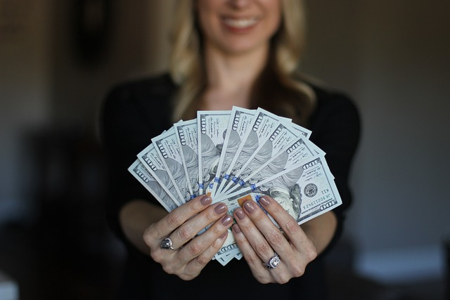 a woman holding cash in hand